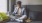 man on a couch looks at his tablet