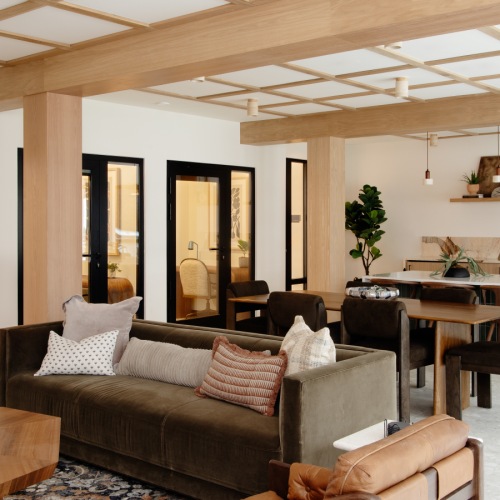 a clubroom with a couch, tables and chairs