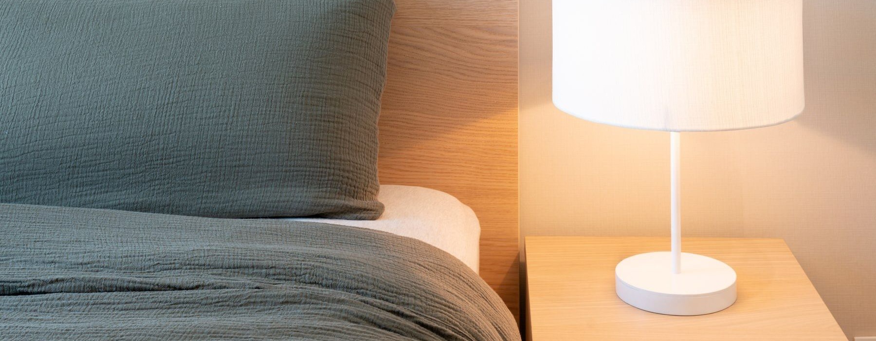 bed with lamp on table