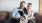a man and a woman sitting on a couch with a dog